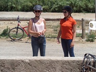 Preparing a horsebackriding tour in the countryside with instructor 