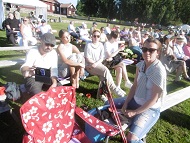 A concert even outside town in a nice park with sunshine